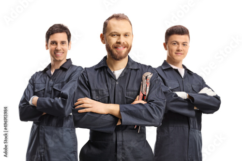 Team of plumbers in uniforms looking at camera photo