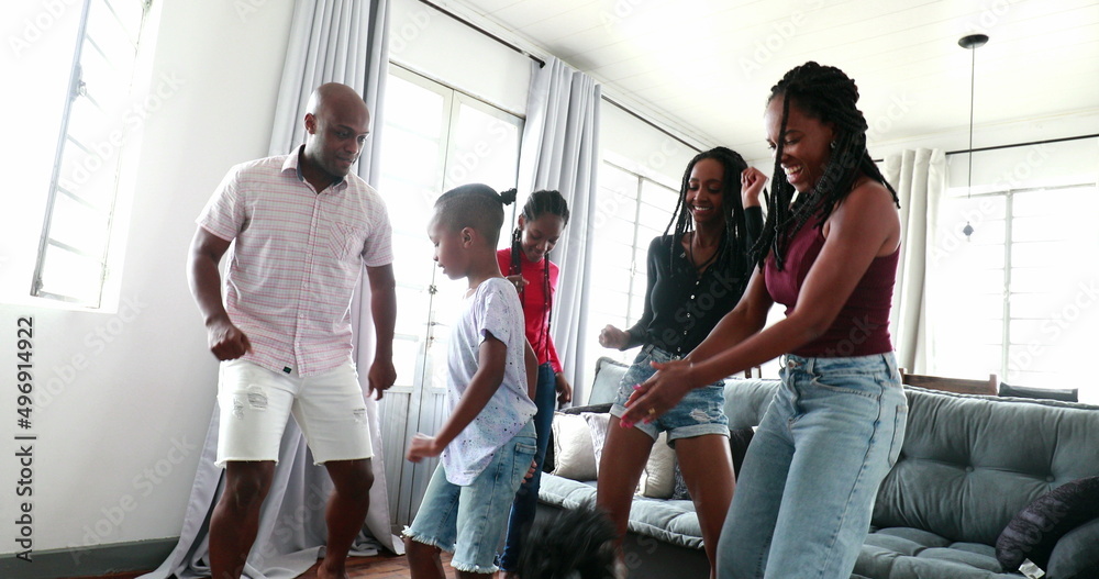 Happy family celebrating dancing at home living-room Happy family celebrating dancing at home living-room
