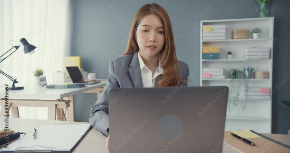 Young asia businesswoman using laptop on table working and communicate sitting on office desk at workplace. Remote webinar, internet technology, lifestyle social distancing and work after coronavirus. Young asia businesswoman using laptop on table working and communicate sitting on office desk at workplace. Remote webinar, internet technology, lifestyle social distancing and work after coronavirus.
