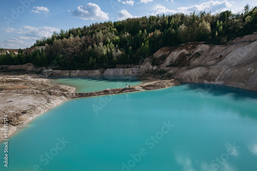 Quarry and golden beach with beautiful blue, turquoise water. Wedding couple walking. Ukraine. concept, vacation, travel, nature and landscape