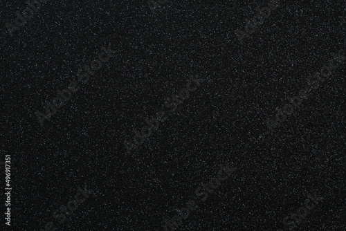 Black glitter surface. Texture. View from above. Closeup