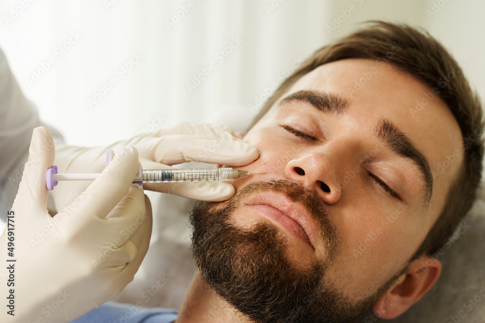 Male client during filler injections in a clinic