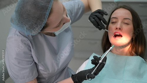 Close up of a female dentist giving her patient an anesthesia injection in dental clinic