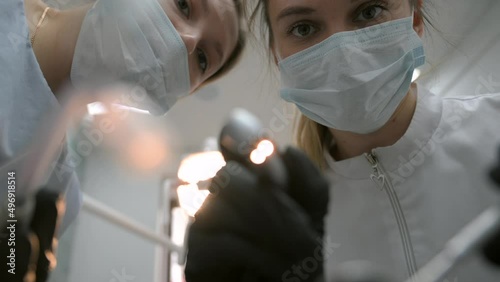 Dentist examining patient's teeth, first person view.