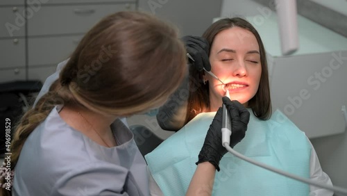 Female dentist at work. Dental treatment in a modern dental clinic. Close up