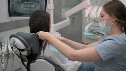 Dentist at work, dentistry. Young female doctor preparing female patient for dental treatment