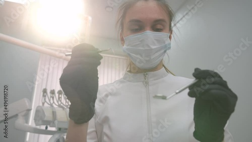 Dentist examining patient's teeth, first person view.