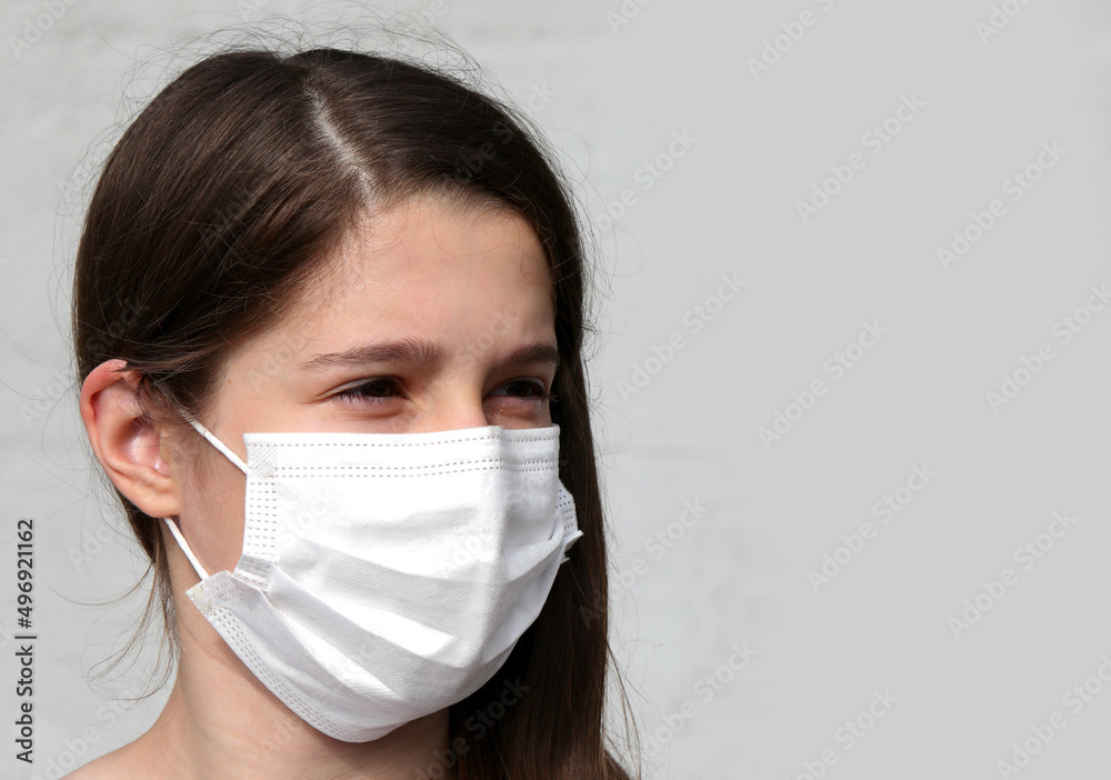 girl with long brown hair with white mask to protect herself girl with long brown hair with white mask to protect herself