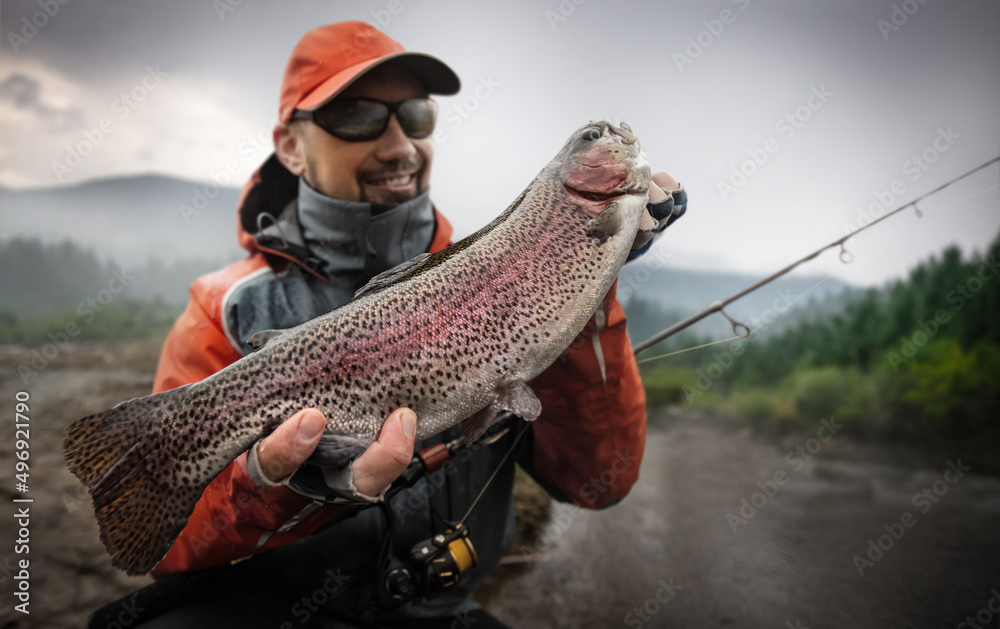 Fisherman and trophy trout. Fishing background. Fisherman and trophy trout. Fishing background.