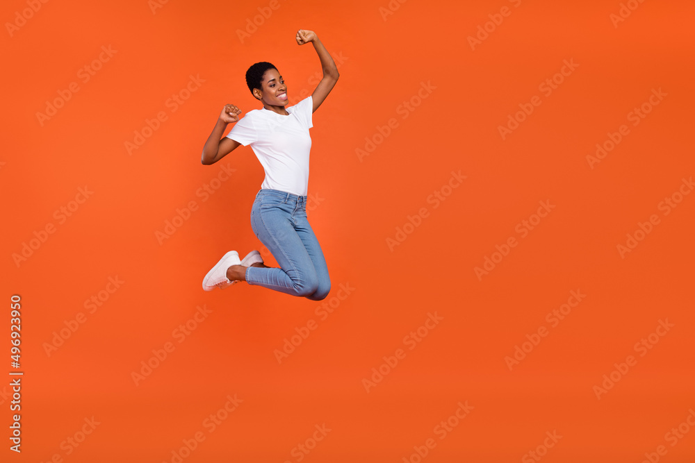Photo of beautiful butch short hair stylish trendy androgyne lady jump fist up victory isolated shine color background