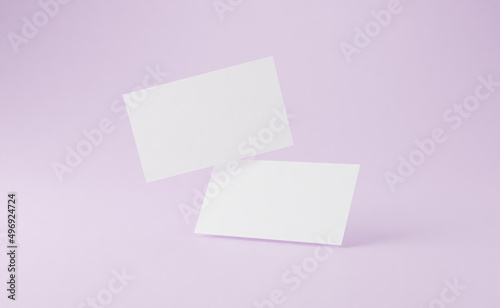 Business card mockup on pink background.