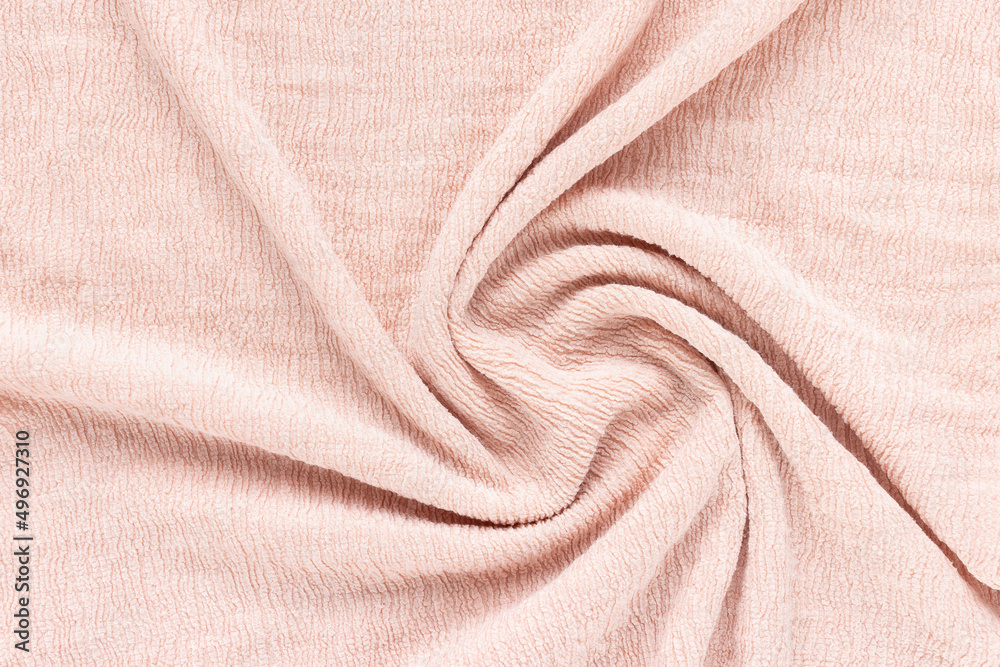 Soft pink fabric with puckered texture twisted in spiral. Abstract background. Fashion and clothes design trends concept Soft pink fabric with puckered texture twisted in spiral. Abstract background. Fashion and clothes design trends concept