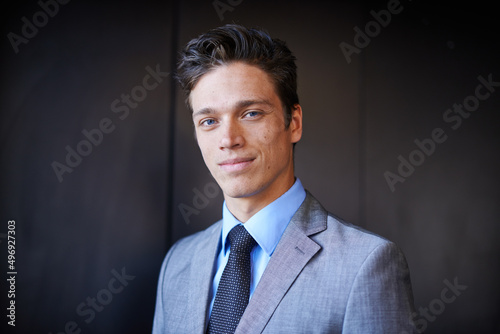 Hes a cut above the rest. Portrait of a handsome young businessman in a suit standing indoors.