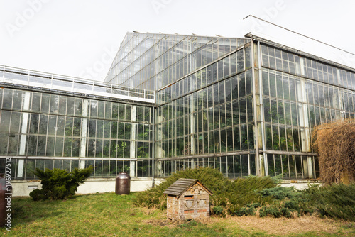 Poznan, Poland - February 24, 2022: Greenhouse building in the Park Wilsona with palms inside. Glass building. © Kseniia