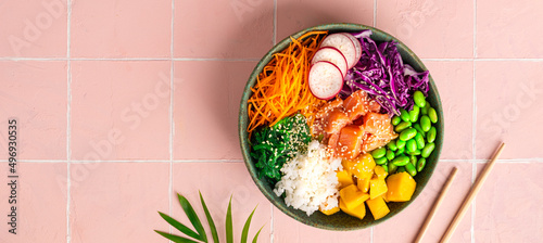 Hawaiian poke bowl with salmon in a bowl with seaweed, sesame seeds and cabbage. Top view, flat lay, Banner