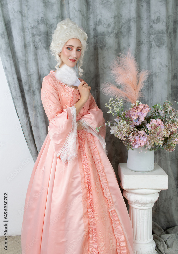 Fototapeta premium Young pretty woman closeup in pink royal dress. Marie Antoinette cosplay