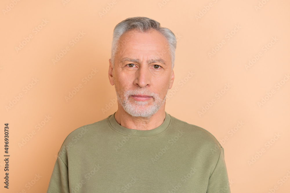 Photo of nice old white hairdo man wear grey pullover isolated on beige color background Photo of nice old white hairdo man wear grey pullover isolated on beige color background