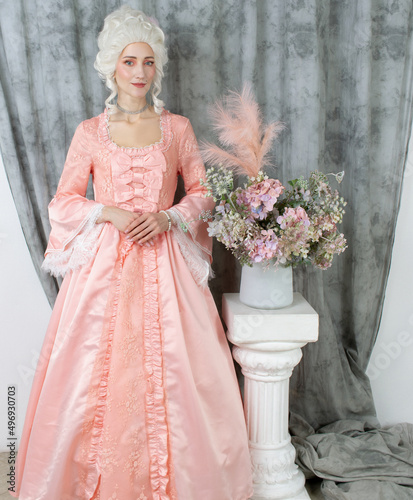Young pretty woman closeup in pink royal dress. Marie Antoinette cosplay