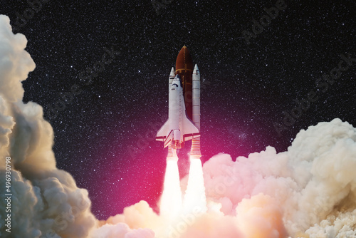Fototapeta Naklejka Na Ścianę i Meble -  Spaceship lift off. Space shuttle with smoke and blast takes off into the starry sky. Rocket starts into space. Concept. Elements of this image furnished by NASA.