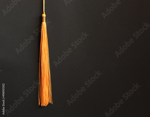 Graduation concept with academical tassel on balck background