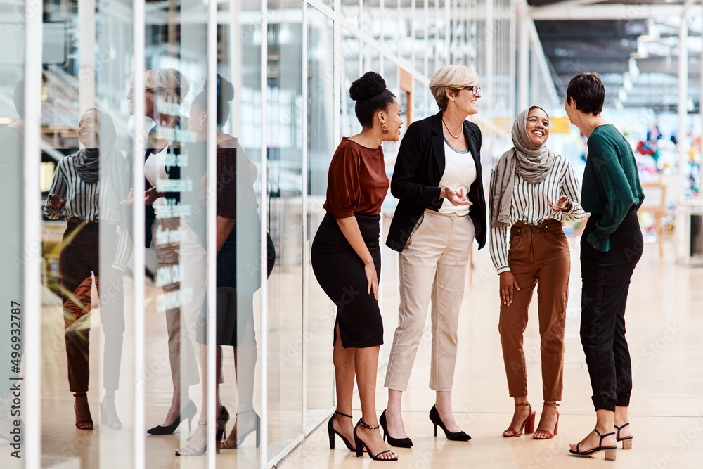 Naklejka premium They share a solid friendship as colleagues. Shot of a group of businesswomen chatting to each other in an office.