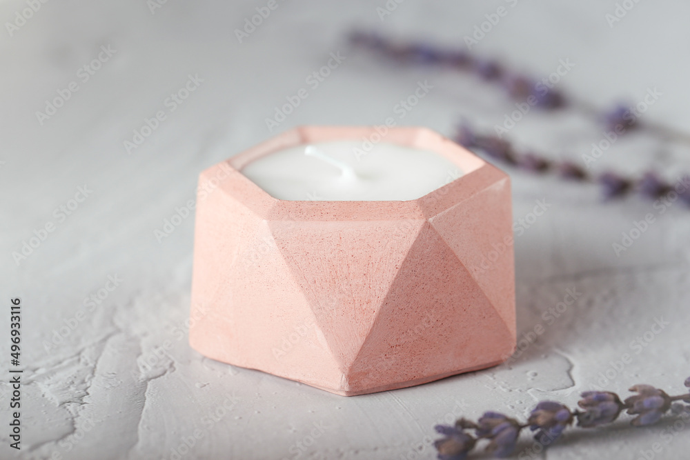 a candle made of soy wax in a plaster mold. natural handmade interior candles.
