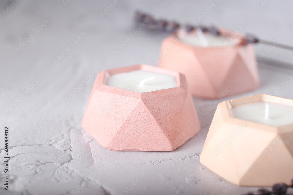 a candle made of soy wax in a plaster mold. natural handmade interior candles. a candle made of soy wax in a plaster mold. natural handmade interior candles.