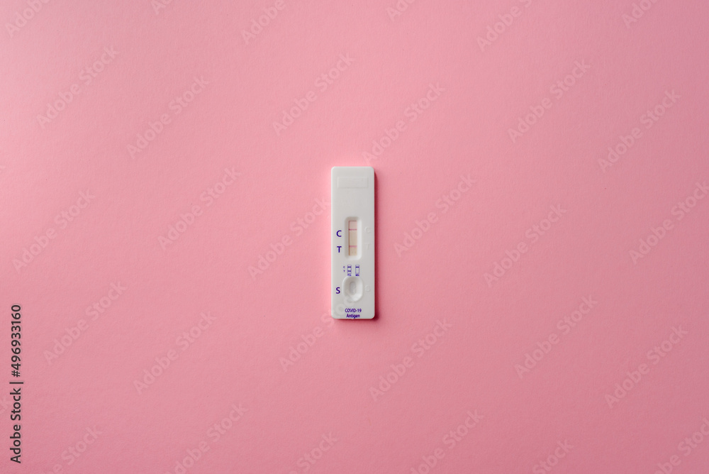 Coronavirus self-test kit. Express test for covid-19 with a positive result on a pink background. Coronavirus self-test kit. Express test for covid-19 with a positive result on a pink background.
