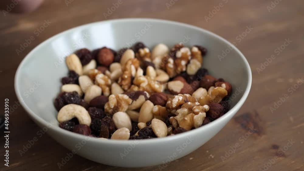 People taking healthy snacks from a bowl People taking healthy snacks from a bowl