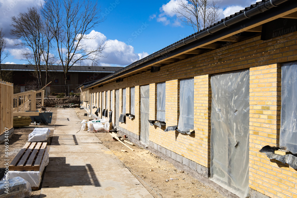 Herlev, Denmark - April 3, 2022: New house under construction and building materials. High quality photo