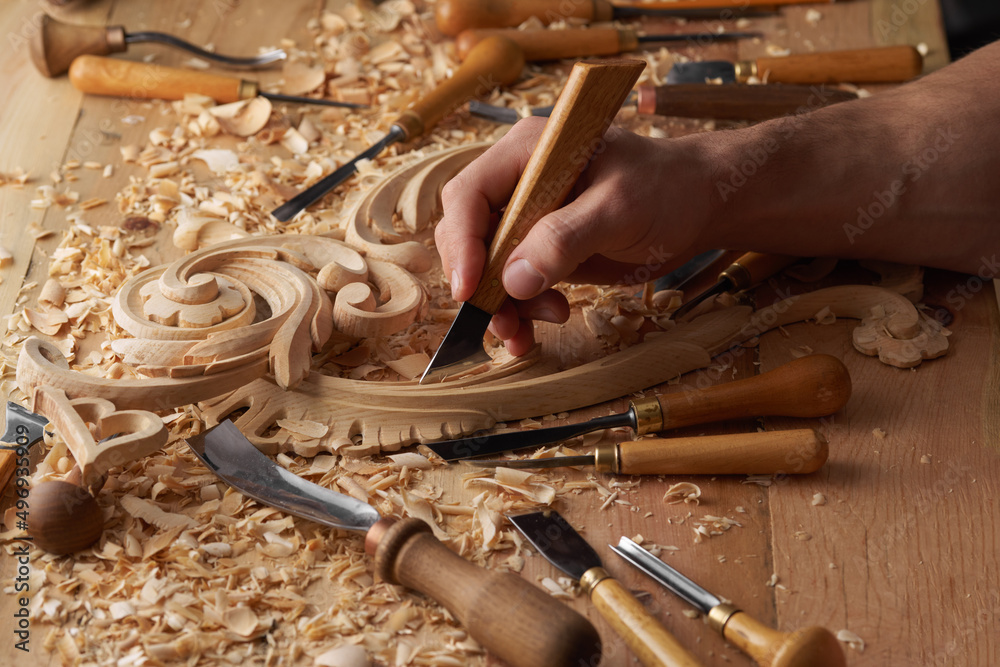 Stockfoto Woodwork and Wood carving. Carpenter s hands use chiesel