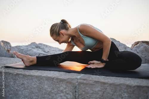Teenager Girl Practicing Yoga Near The Sea Beach