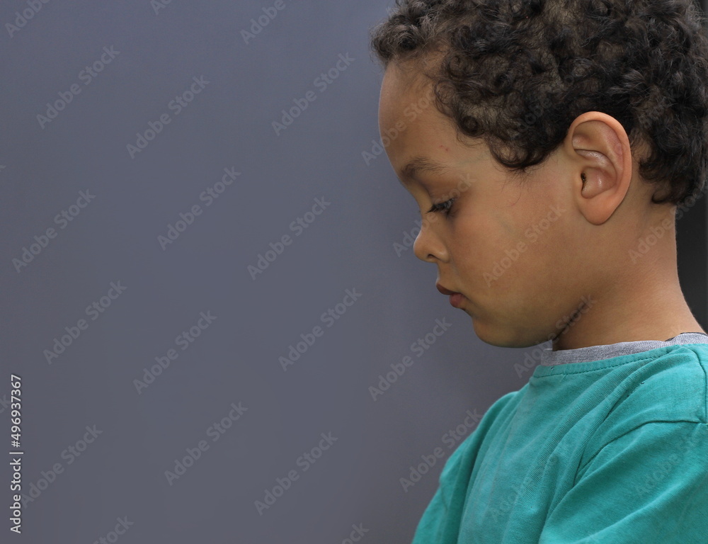 little boy praying to God with eyes closed with grey background stock photo little boy praying to God with eyes closed with grey background stock photo