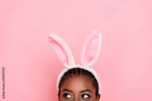 Portrait of dreamy person half face look interested empty space isolated on pink color background