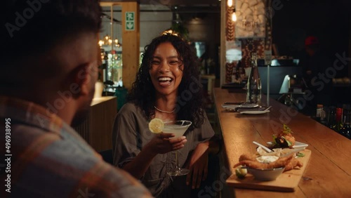 African American female on date with boyfriend drinking cocktails