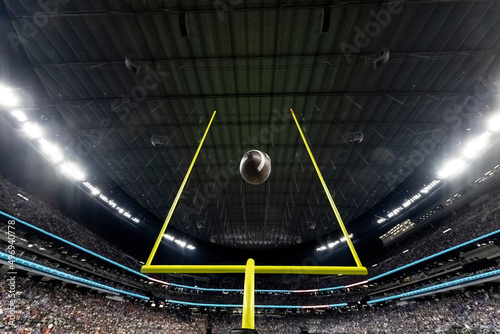 Field Goal Posts in a large indoor football stadium during a game. Generic Football background image photo