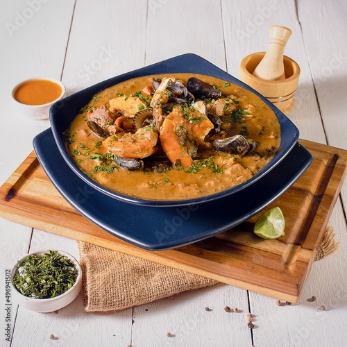 Fanesca de Mariscos con pescado, ostras, camarón en plato azul para semana santa photo