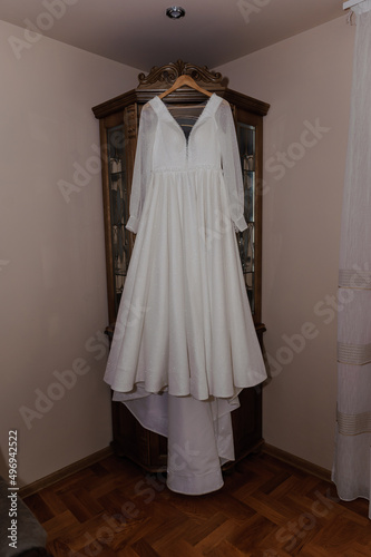 White dress of the bride on a hanger. Wedding