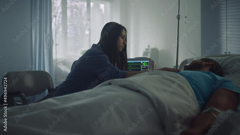 Woman comfort sick man in hospital ward. Modern clinic operating room interior. Woman comfort sick man in hospital ward. Modern clinic operating room interior.