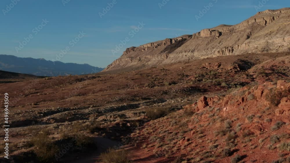 Aerial flying backwards showing red desert landscape in southern utah at sunset Aerial flying backwards showing red desert landscape in southern utah at sunset