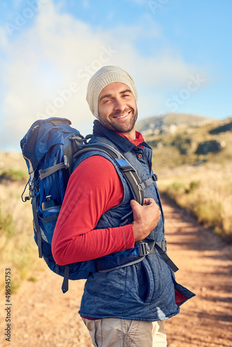 Im off to see where this trail leads. Portrait of a happy hiker out on a mountain hiking trail on his own. © Tamani C/peopleimages.com