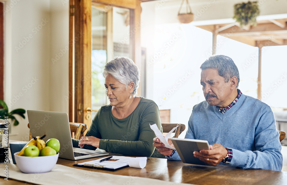 Time to get their household budget together. Shot of a mature couple managing their paperwork together at home.