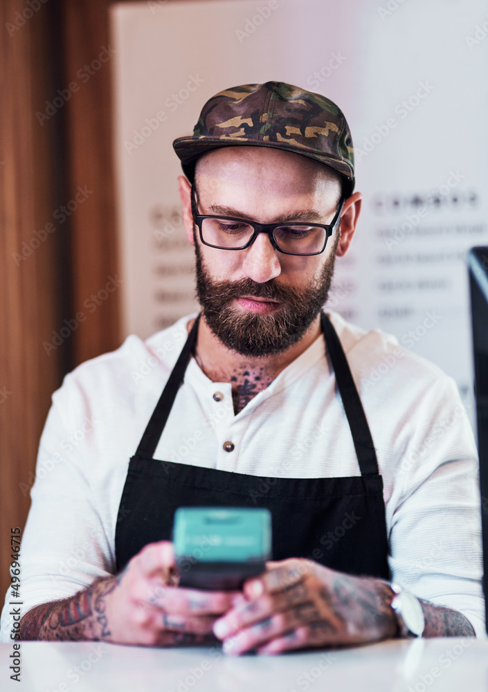 This removes all the hassles of making payment. Cropped shot of a handsome young barber using a card machine inside his barbershop. This removes all the hassles of making payment. Cropped shot of a handsome young barber using a card machine inside his barbershop.