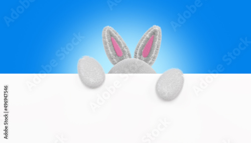 Cartoon rabbit holds space for text. Furry rabbit ears, 3d render. Happy Easter banner, poster, greeting card, copy space.