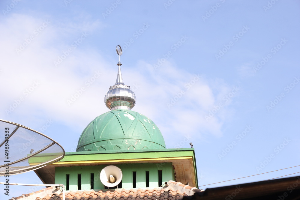 loudspeakers or toa in the mosque which is usually used to announce the call to prayer. blue sky background