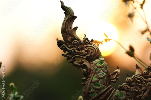 The picture of wood carving and stained glass decoration on the piece is a handicraft work in the north of Thailand.