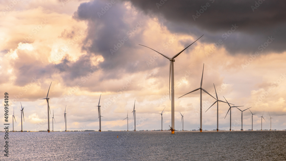 Offshore Windfarm at sea under cloudy sky