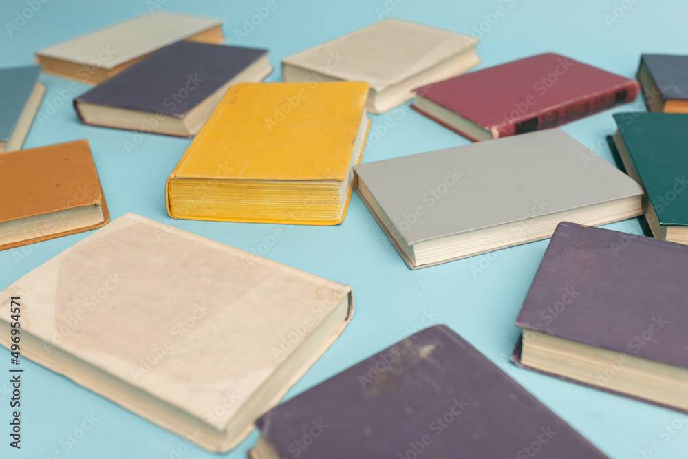 Old books on light blue table, top view. World Book Day background Old books on light blue table, top view. World Book Day background