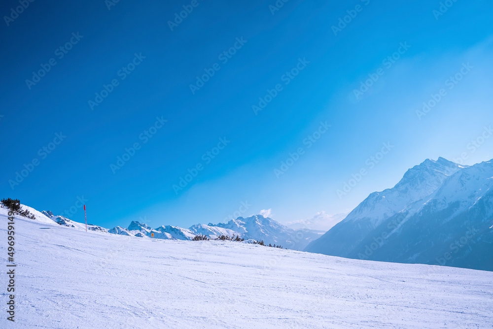 Scenic view of snow covered mountain against clear blue sky