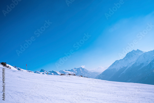 Scenic view of snow covered mountain against clear blue sky © ingusk